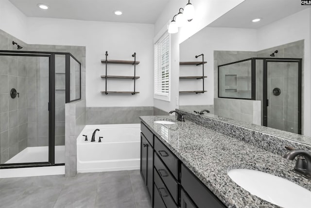 bathroom featuring a shower stall, a bath, and a sink