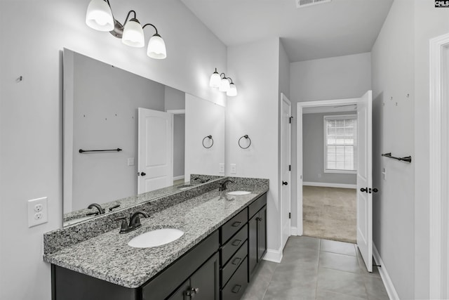 full bathroom featuring a sink, visible vents, double vanity, and tile patterned flooring