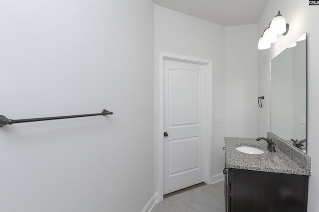 bathroom with vanity, baseboards, and tile patterned flooring