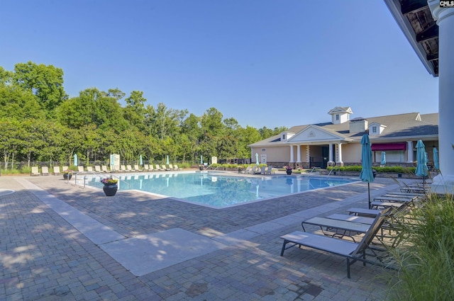 pool featuring a patio area and fence