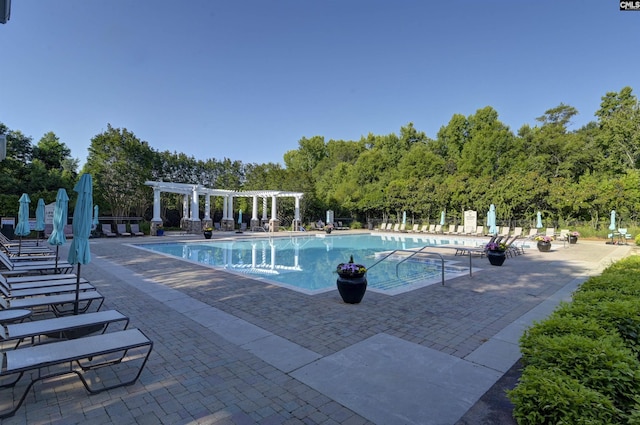 community pool with a patio, fence, and a pergola