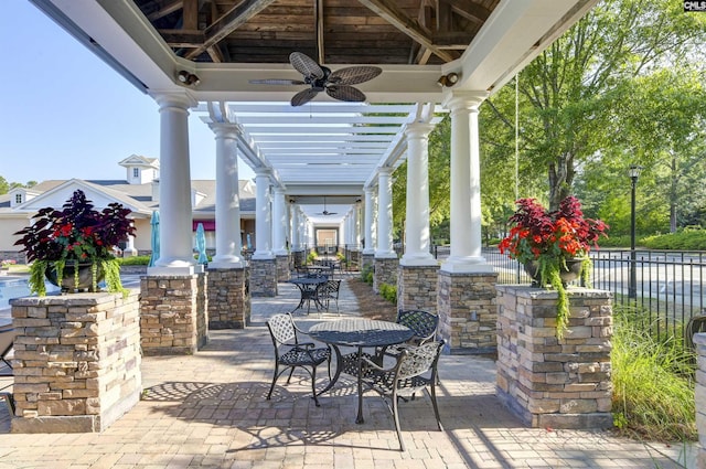 view of patio / terrace featuring a gazebo, outdoor dining space, a ceiling fan, and fence