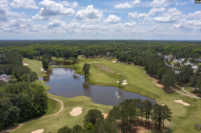 bird's eye view with a wooded view, golf course view, and a water view