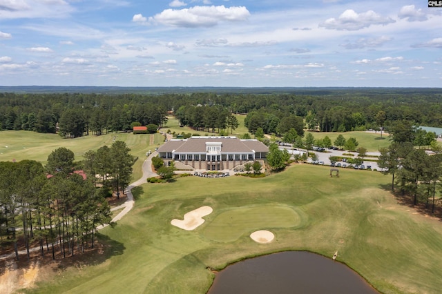 birds eye view of property with golf course view and a forest view