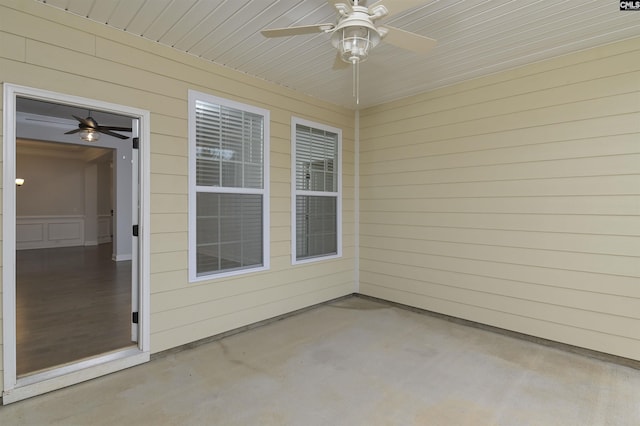 unfurnished sunroom featuring wooden ceiling and ceiling fan