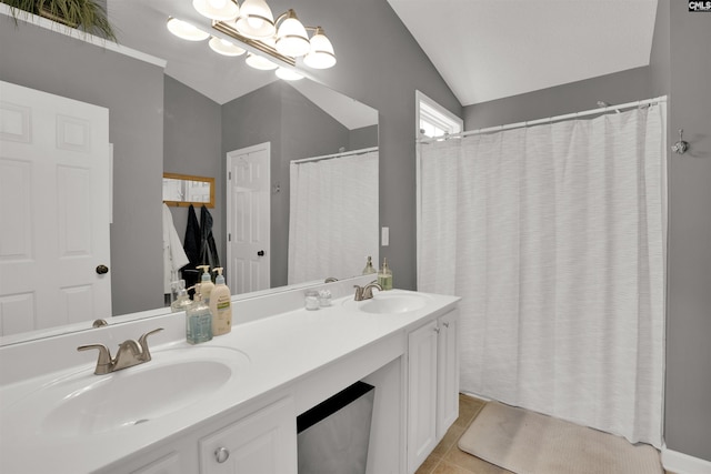 full bathroom featuring tile patterned floors, double vanity, lofted ceiling, and a sink