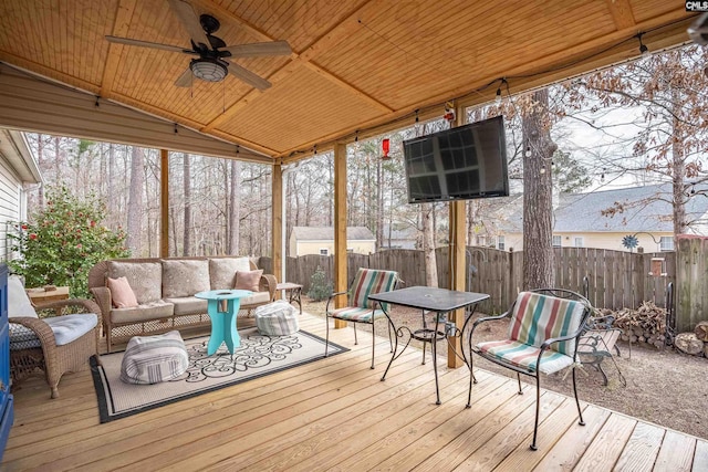 deck featuring an outdoor hangout area, ceiling fan, and fence