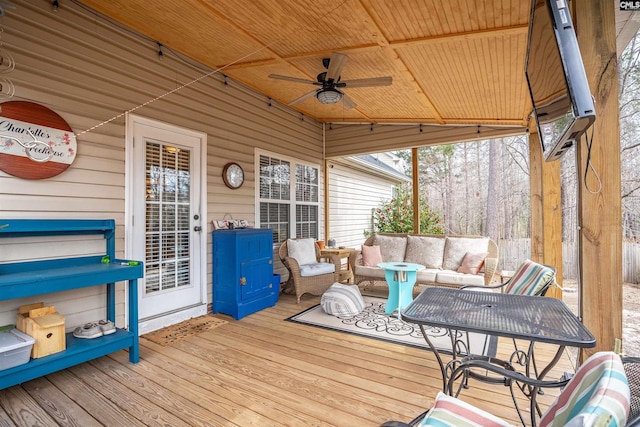 deck with an outdoor hangout area and ceiling fan