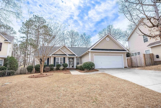 view of front facade with fence, a garage, and driveway