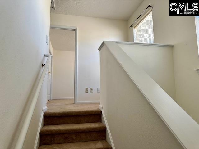 staircase featuring baseboards