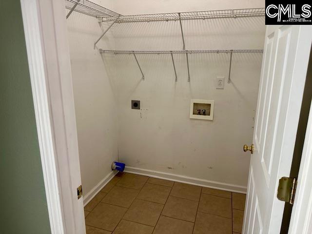 laundry area featuring electric dryer hookup, tile patterned flooring, baseboards, hookup for a washing machine, and laundry area