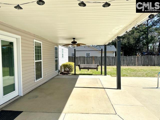 view of patio / terrace with a ceiling fan and fence