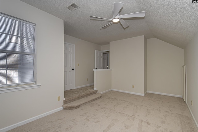 interior space featuring plenty of natural light, a textured ceiling, and ceiling fan