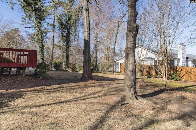 view of yard with a deck and fence