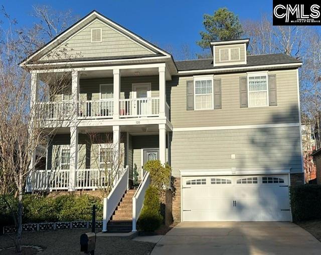 view of front of home with stairway, a porch, a garage, a balcony, and driveway