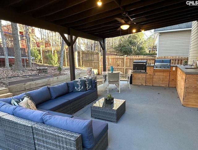 view of patio / terrace featuring a sink, area for grilling, a grill, and outdoor dining space