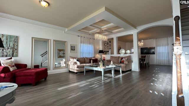 living room featuring arched walkways, coffered ceiling, an inviting chandelier, and wood finished floors