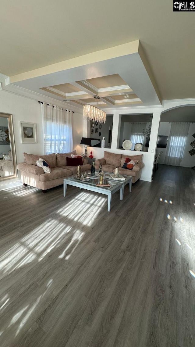 unfurnished living room featuring dark wood finished floors, coffered ceiling, and a chandelier