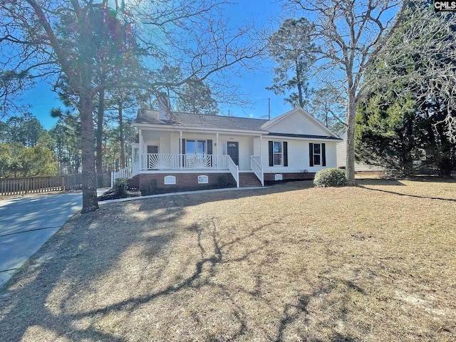 ranch-style home featuring fence, a porch, a front yard, crawl space, and driveway