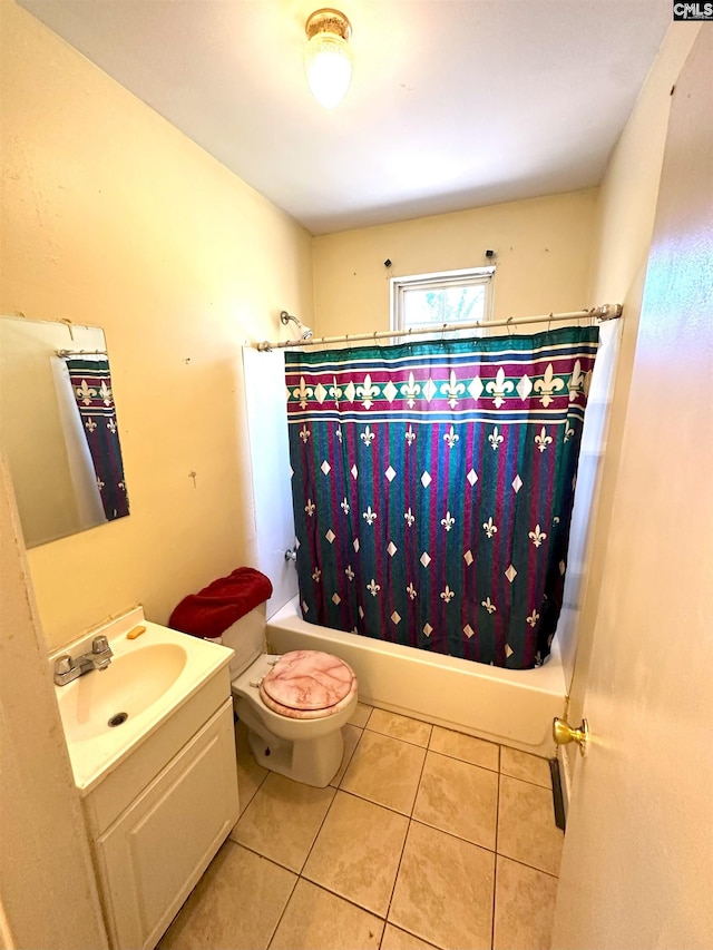 bathroom featuring tile patterned flooring, vanity, toilet, and shower / tub combo