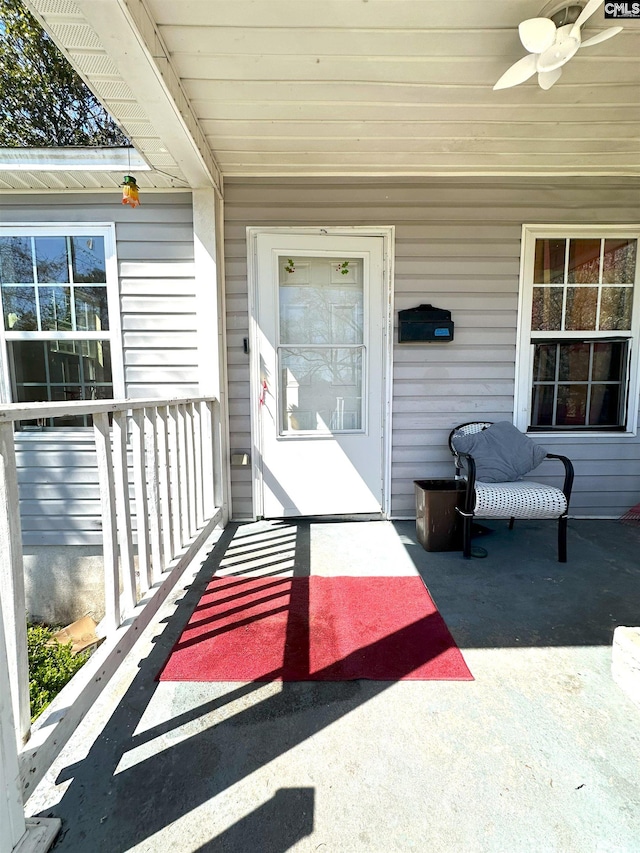 property entrance featuring a porch and ceiling fan