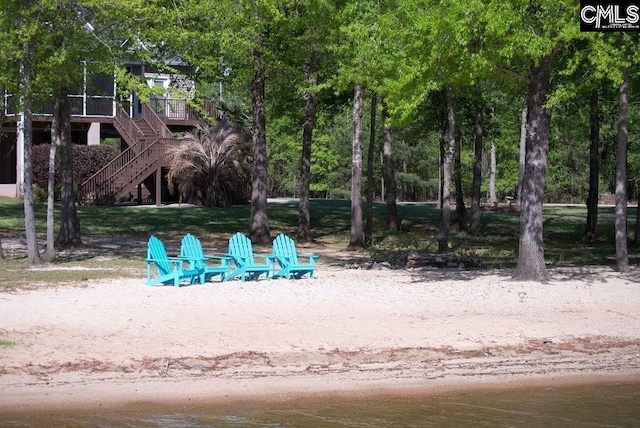 surrounding community with a fire pit and stairs