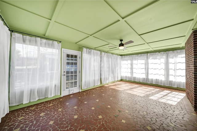 unfurnished sunroom with plenty of natural light and a ceiling fan