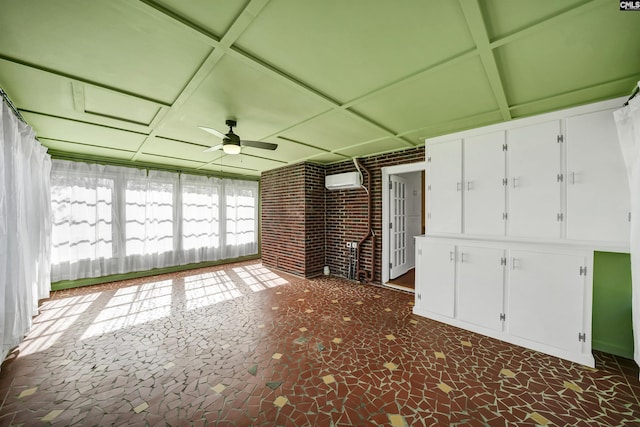 unfurnished sunroom with coffered ceiling, a ceiling fan, and a wall mounted AC