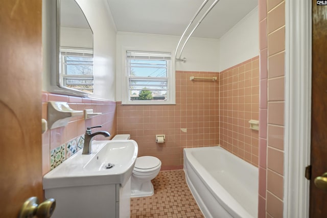 full bathroom with vanity, ornamental molding, tile walls, toilet, and shower / bathtub combination