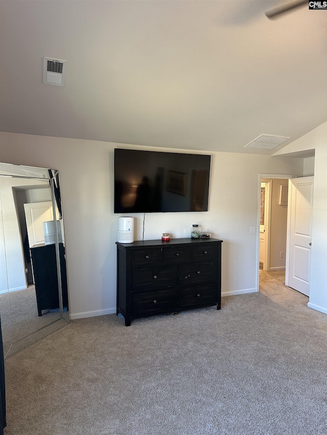 carpeted living area with visible vents and baseboards