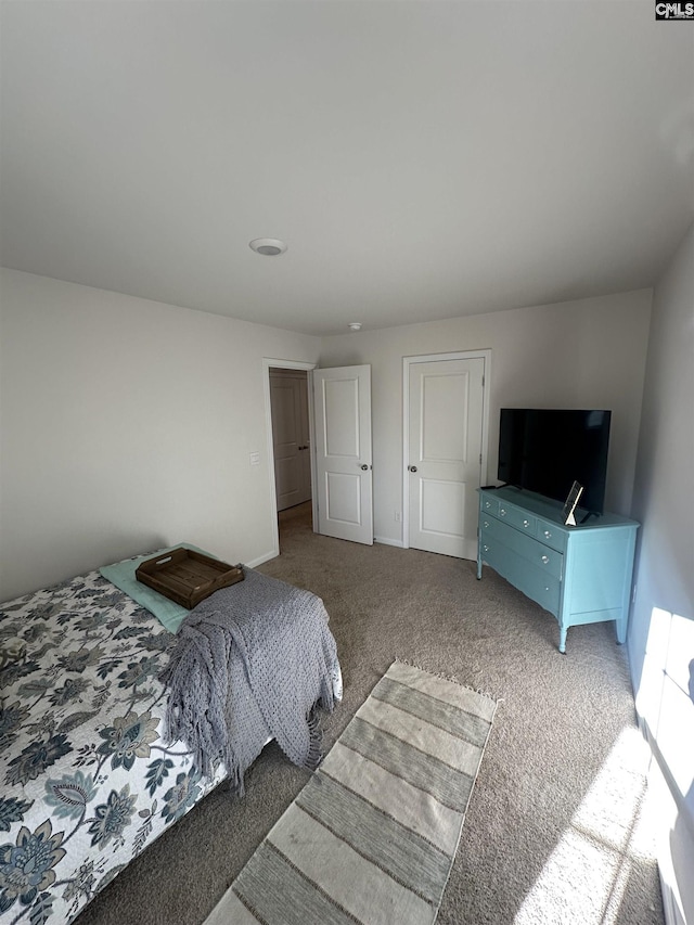 carpeted bedroom featuring baseboards