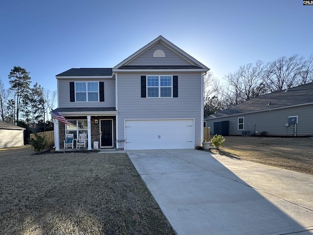 traditional home featuring a front lawn, a porch, concrete driveway, and an attached garage