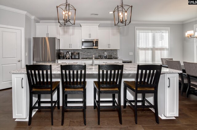 263 Compass Trl, Blythewood, SC 29016 - kitchen with an inviting chandelier, ornamental molding, an island with sink, and stainless steel appliances