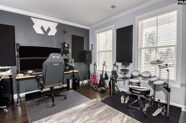 office area with baseboards, wood finished floors, visible vents, and ornamental molding