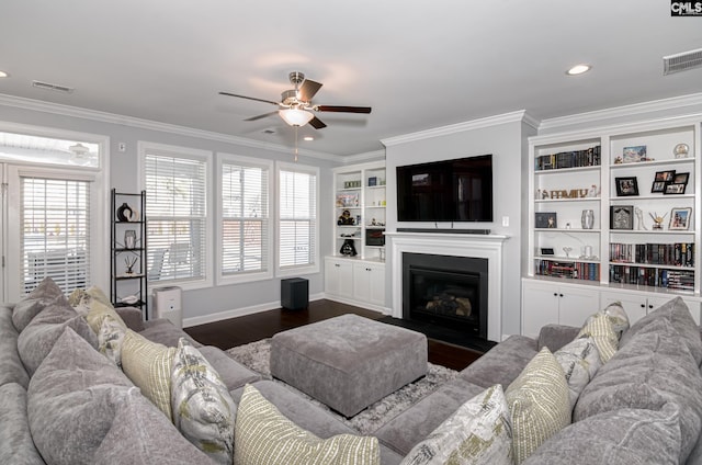 263 Compass Trl, Blythewood, SC 29016 - living room with visible vents, dark wood-type flooring, a glass covered fireplace, and ornamental molding