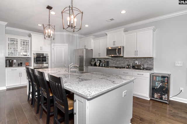 263 Compass Trl, Blythewood, SC 29016 - kitchen featuring a sink, dark wood-type flooring, wine cooler, appliances with stainless steel finishes, and crown molding