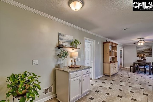 kitchen with visible vents, open shelves, ceiling fan, ornamental molding, and a textured ceiling