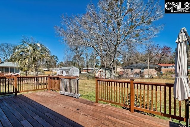 deck with a residential view and a lawn