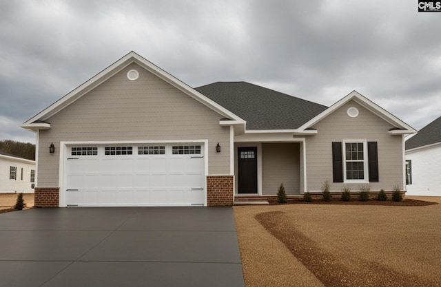 view of front of home with concrete driveway, an attached garage, brick siding, and roof with shingles