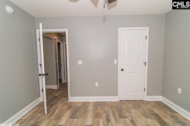 unfurnished bedroom with baseboards, light wood finished floors, and ceiling fan