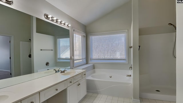 bathroom featuring a wealth of natural light, lofted ceiling, and walk in shower