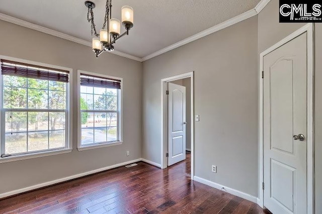 spare room with dark wood finished floors, a chandelier, baseboards, and ornamental molding