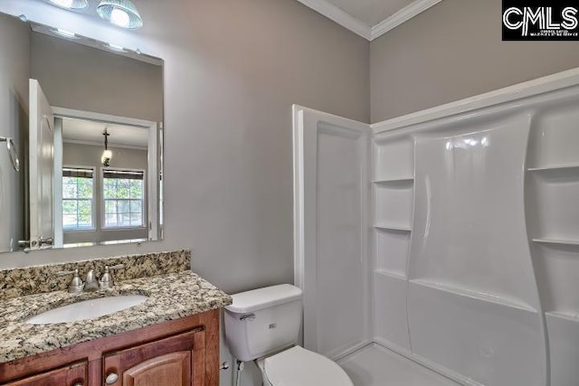 full bath featuring vanity, toilet, a shower, and ornamental molding