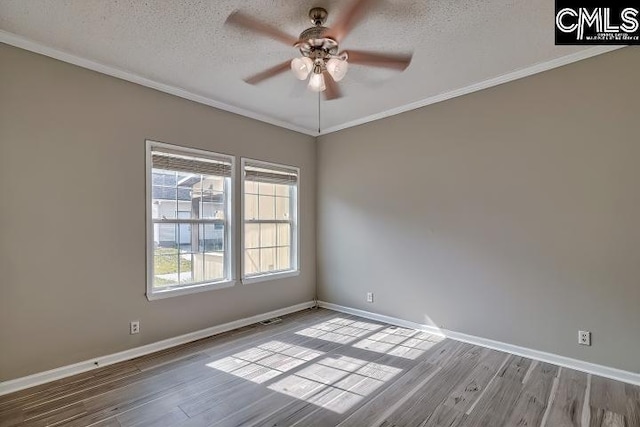 unfurnished room featuring crown molding, baseboards, wood finished floors, a textured ceiling, and a ceiling fan