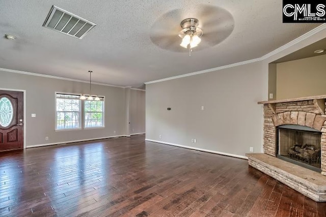 unfurnished living room with visible vents, ceiling fan, a fireplace, a textured ceiling, and dark wood-style flooring