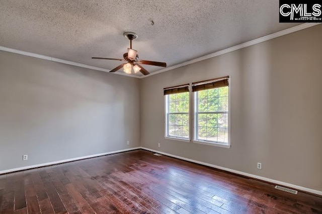 spare room featuring dark wood finished floors, ceiling fan, visible vents, and ornamental molding