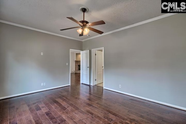 empty room featuring ornamental molding, baseboards, a ceiling fan, and dark wood-style flooring