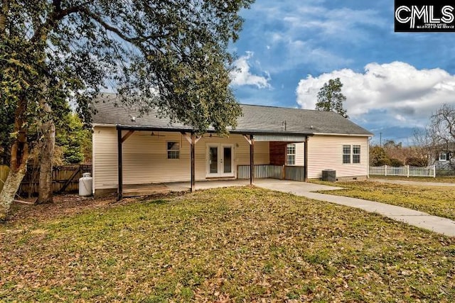 back of house with a patio area, a yard, fence, and french doors