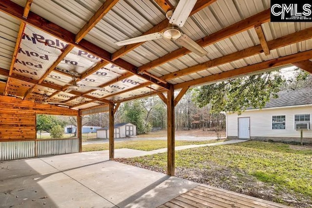 view of patio / terrace with ceiling fan, a storage shed, and an outdoor structure