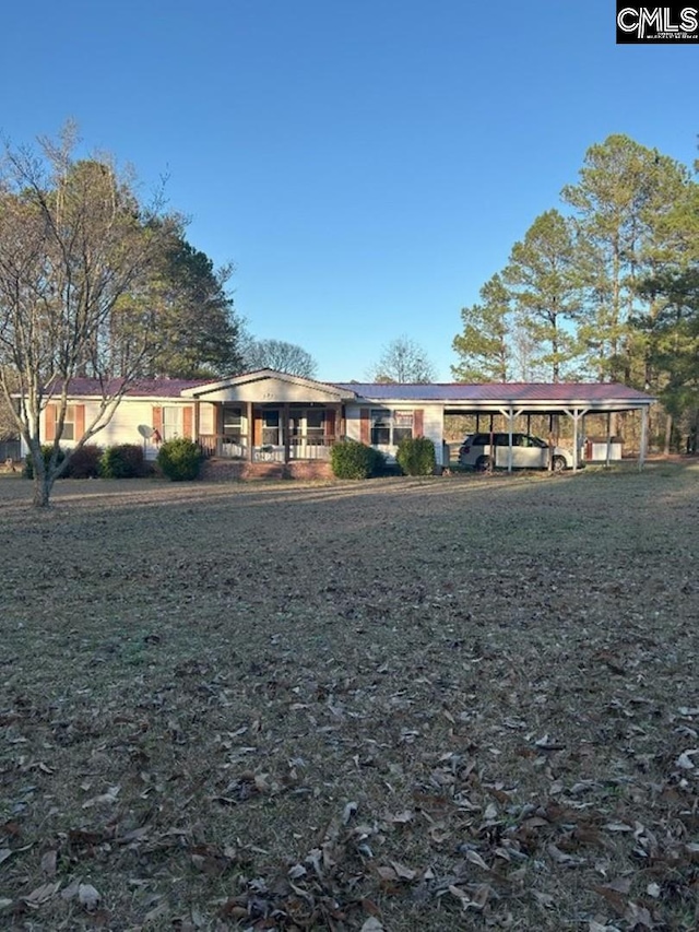 single story home featuring a carport and a front yard